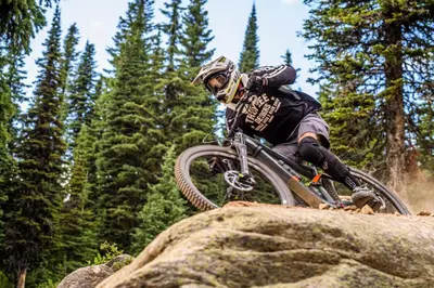 a person on a bike jumping over a rock at Bear's Paw Chalet - Amazing Location & Ski In-Out in Big White