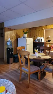 a living room with a table and chairs and a kitchen at Charming - 2 bedrooms suite, 1 full bath & family room in Kamloops