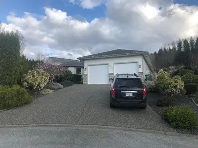 a car parked in the driveway of a house at Licensed spacious basement suite with one king-size bed in Chilliwack