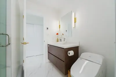 a bathroom with a toilet and a sink and a shower at Steveston Village Bed and Breakfast in Richmond
