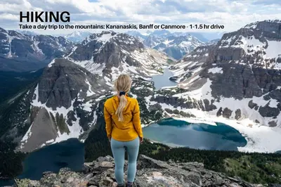 a woman standing on top of a mountain overlooking a lake at LUXURY DT, 2 Bedroom DEAL, Private Balcony, Full Kitchen, Gym - FREE PARKING in Calgary