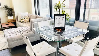 a living room with a table with a laptop on it at LUXURY DT, 2 Bedroom DEAL, Private Balcony, Full Kitchen, Gym - FREE PARKING in Calgary