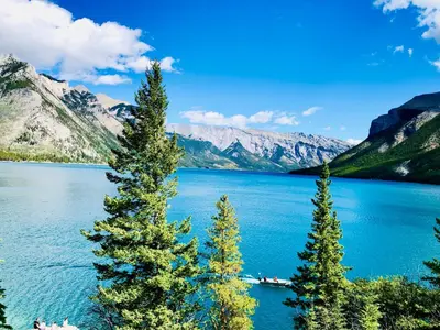 a view of a lake with trees and mountains at A Romantic Studio with Full Kitchen & AC-141 in Canmore