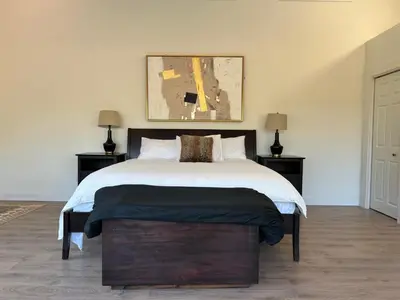 a bedroom with a large bed and two lamps at Country home, Sleeps 6 pets friendly in Port Alberni