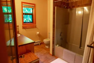 a bathroom with a shower and a sink and a toilet at The Overlook, Luxury Lakeside Home with Dock in Harrison Hot Springs