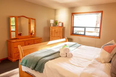 a bedroom with a bed with a teddy bear on it at The Overlook, Luxury Lakeside Home with Dock in Harrison Hot Springs