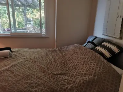 a bed in a bedroom with a window at Vancouver sea view Palace inn in West Vancouver