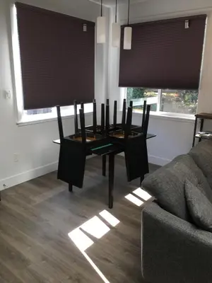 a dining room table with chairs and a couch at The Purple Door Carriage House in Lantzville