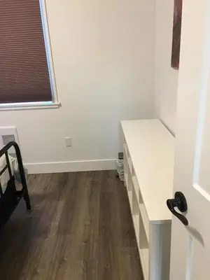 a room with a white desk and a window at The Purple Door Carriage House in Lantzville