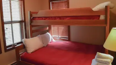 a bedroom with two bunk beds in a room at Woodhaven #18 by Bear Country in Sun Peaks