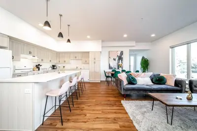 a kitchen and living room with a couch and a table at Exotic,LUSH,Rainforest,CR,Suite,King,U/G,Wifi in Edmonton