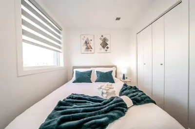 a bedroom with a bed with a blanket on it at Exotic,LUSH,Rainforest,CR,Suite,King,U/G,Wifi in Edmonton