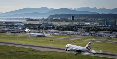 two airplanes are taking off from an airport runway at Charming, Cheerful, Exquisite 4 BR house, free wifi, free parking, free cancelation in Langley
