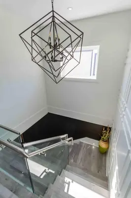 a dining room with a glass table and a chandelier at Charming, Cheerful, Exquisite 4 BR house, free wifi, free parking, free cancelation in Langley