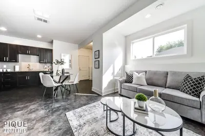a living room with a couch and a table at Stunning Modern Suite - King Bed - Free Parking & Netflix - Fast Wi-Fi - Long Stays Welcome in Edmonton
