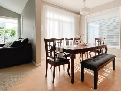 a dining room with a table and chairs at Serene and Secure Home Sweet Home with Office, 15 mins to Airport, 20 mins to Downtown, 90 mins to Banff in Calgary