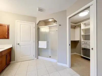 a bathroom with a shower and a walk in closet at Serene and Secure Home Sweet Home with Office, 15 mins to Airport, 20 mins to Downtown, 90 mins to Banff in Calgary
