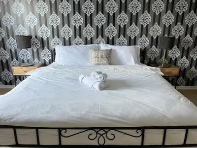 a bedroom with a bed with towels on it at Serene and Secure Home Sweet Home with Office, 15 mins to Airport, 20 mins to Downtown, 90 mins to Banff in Calgary