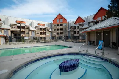a swimming pool at a apartment complex with buildings at Ski-in/Ski-out Intentionally Designed Ski Lodge in Whistler