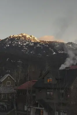a snow covered mountain with houses in front of it at Ski-in/Ski-out Intentionally Designed Ski Lodge in Whistler