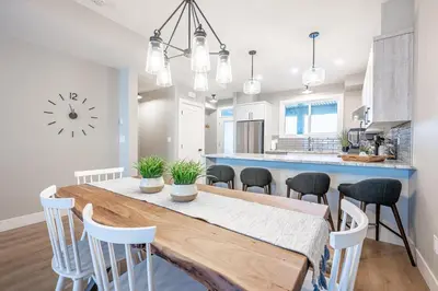 a kitchen and dining room with a table and chairs at Grizzly Ridge Getaway - Private Hot Tub, Mtn View & Sleeps 11 in Big White