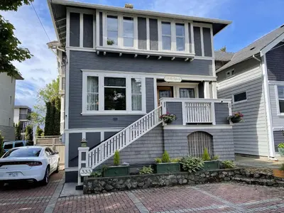 a house with a white car parked in front of it at Fisher House Victoria Bed and Breakfast in Victoria
