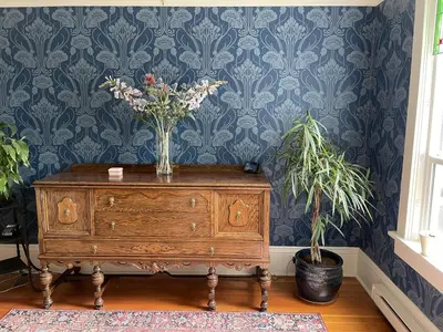 a vase of flowers on a dresser in a room at Fisher House Victoria Bed and Breakfast in Victoria