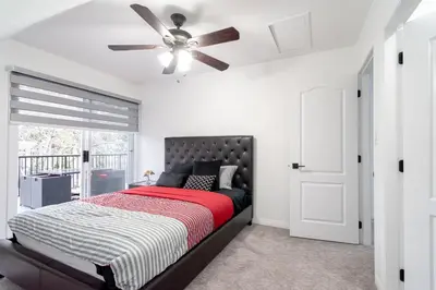 a bedroom with a bed and a ceiling fan at Spacious & Modern by the Beach in White Rock