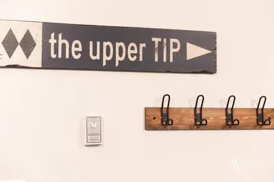 a sign that says the upper tip on a wall at The Powder Nook, Hot Pools, Mile 1 Express Chair in Panorama