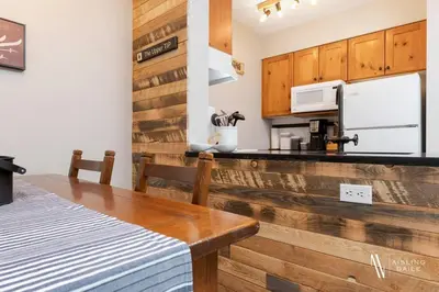 a kitchen with wooden cabinets and a counter top at The Powder Nook, Hot Pools, Mile 1 Express Chair in Panorama