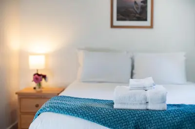 a bedroom with a bed with towels on it at Downie Cottage by Revelstoke Vacations in Revelstoke
