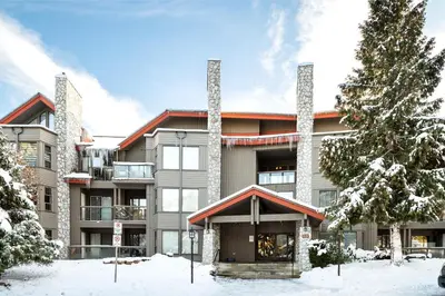an apartment building with snow in front of it at 2BR in Greyhawk, Hot Tub and Sauna, Gas Fireplace, Secure Parking in Whistler