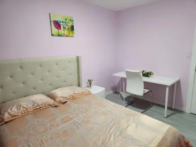 a bedroom with a bed and a desk and a table and chair at private single room in a house in Richmond