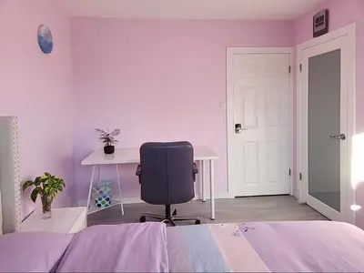 a bedroom with a bed and a desk and a chair at private single room in a house in Richmond