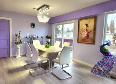 a dining room with a table and a parrot on the wall at private single room in a house in Richmond