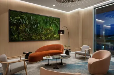 a living room with chairs and a painting on the wall at Delta Hotels by Marriott Vancouver Delta in Delta