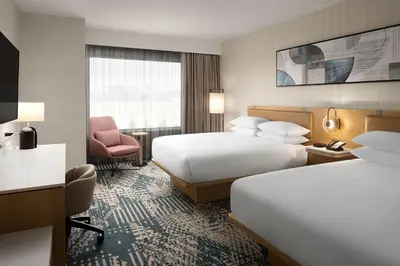 a hotel room with two beds and a chair at Delta Hotels by Marriott Vancouver Delta in Delta