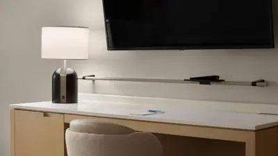 a desk with a lamp and a chair in a room at Delta Hotels by Marriott Vancouver Delta in Delta