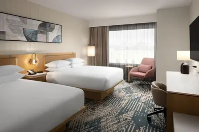 a hotel room with two beds and a chair at Delta Hotels by Marriott Vancouver Delta in Delta