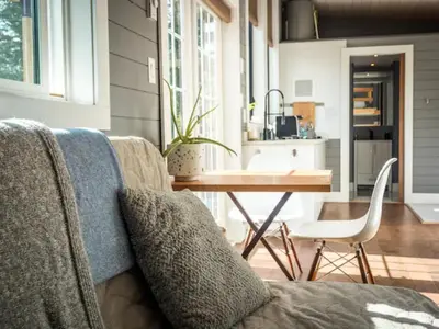 a living room with a couch and a table at Golden Tiny Homes in Golden