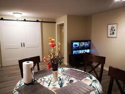 a living room with a table and a television at Jimmy B&B in Surrey