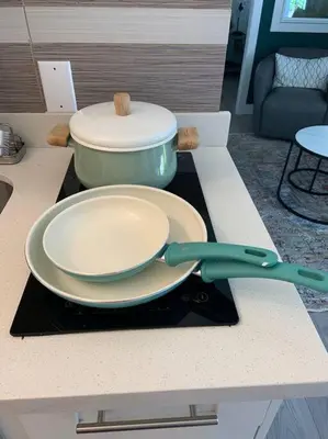 a plate and a pot on a counter with a pair of scissors at King Garden Suite/20 mins to Dwntwn Vancouvr/PetOk in North Vancouver
