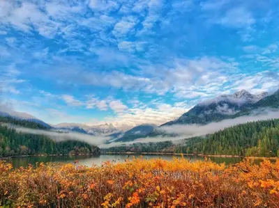 a view of a lake with mountains in the background at King Garden Suite/20 mins to Dwntwn Vancouvr/PetOk in North Vancouver