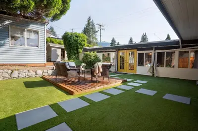 a patio with a table and chairs on a lawn at King Garden Suite/20 mins to Dwntwn Vancouvr/PetOk in North Vancouver