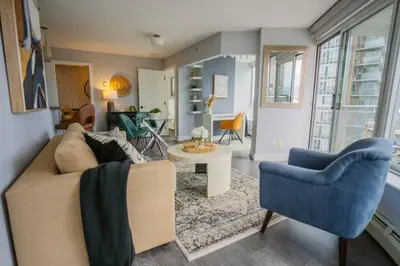 a living room with a couch and two chairs at Downtown King Suite-Surround Views-Pool/Gym/Parkng in Vancouver
