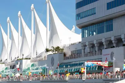 a cruise ship with a crowd of people in front of a building at Downtown King Suite-Surround Views-Pool/Gym/Parkng in Vancouver