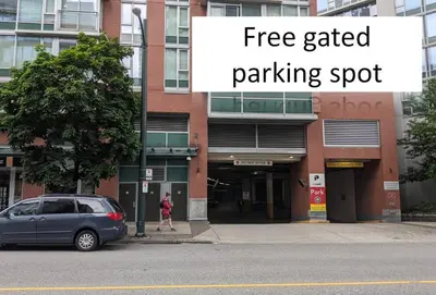 a car parked in front of a building with the words free gated parking spot at Downtown King Suite-Surround Views-Pool/Gym/Parkng in Vancouver