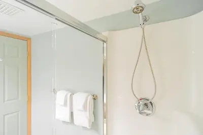 a shower in a bathroom with a glass shower door at The best ski in ski out two bedroom condo at Aspens in Whistler