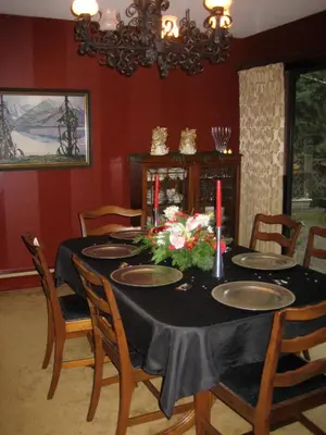 a dining room table with a black table cloth and flowers at Misty Meadows B and B in Langford