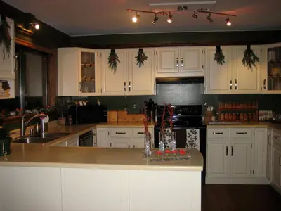 a kitchen with white cabinets and a counter top at Misty Meadows B and B in Langford